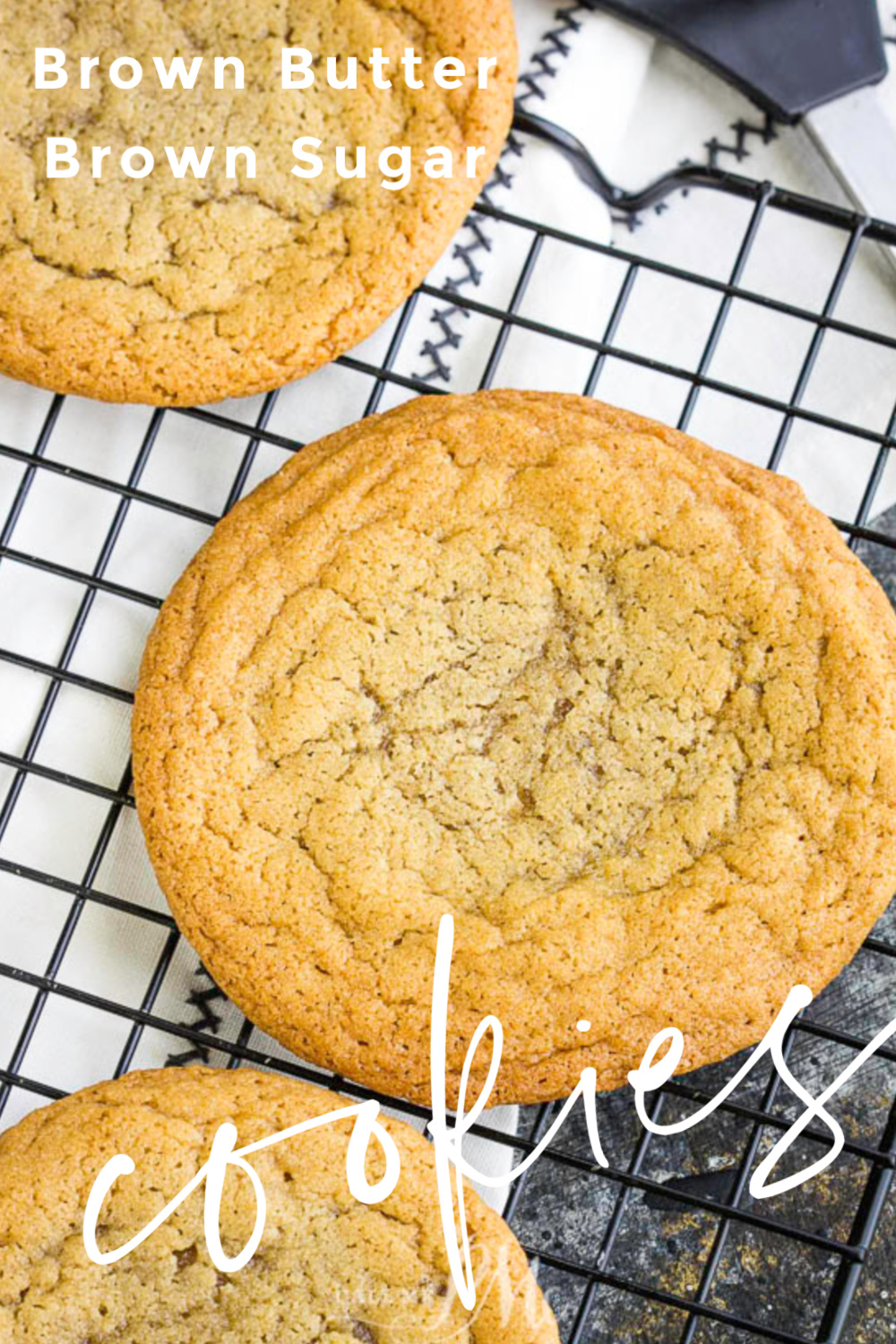 Crunchy around the edges with chewy centers, Browned Butter Brown Sugar Cookie Recipe is packed full of flavor! Cookie perfection! #brownsugar #brownbutter #cookies #recipe #fromscratch #homemade Close-up of cookies on a cooling rack.