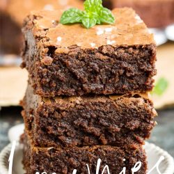 Three stacked brownies with a mint leaf on top are displayed on a small plate, surrounded by more delectable treats in the background. Text overlay reads "Better Than Box" and "callmepmc.com.
