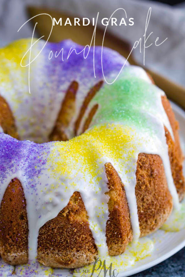 A whole bundt cake on a plate with colored frosting.