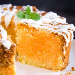 Orange Creamsicle Pound Cake has a bright citrus flavor and a cream soda glaze that you can't stop eating! It's dense, butter, and velvety smooth. #cake #poundcake #poundcakepaula #dessert #recipe #easy #creamsicle #orange #orangecreamsicle #homemade #southern #food #eat #creamcheese #buttermilk