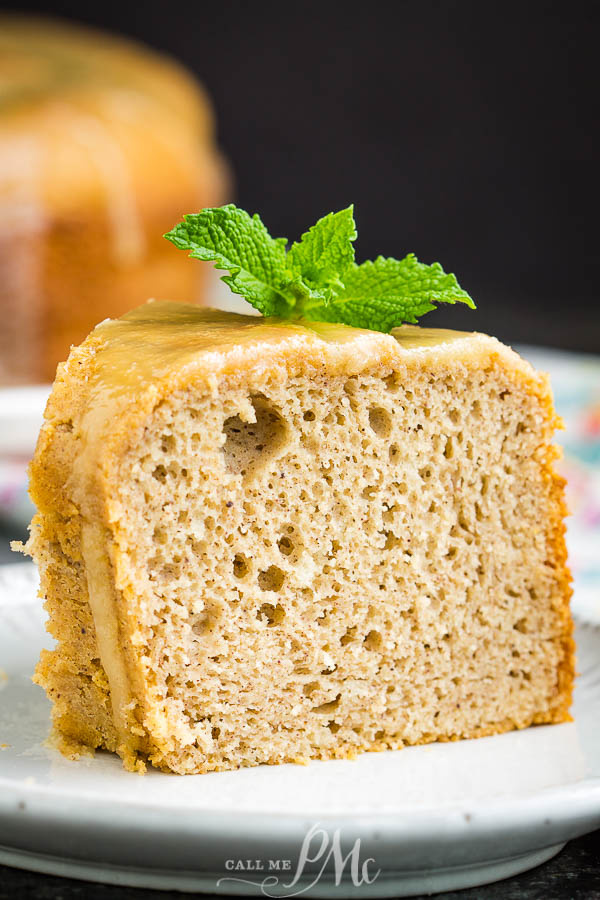 This delicious Cinnamon Crack Cake Recipe is spiced with cinnamon and topped with a rich butter sauce. #cake #bundtcake #dessert #cinnamon #recipes Slice of dessert on a plate.