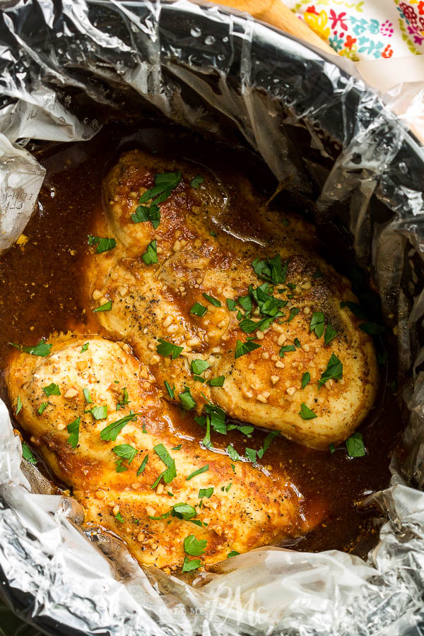 Fall-apart tender, Slow Cooker Asian Glazed Chicken is a super easy recipe that your whole family will love. #slowcooker #chicken #recipe #crockpot #Asian #sweetsour