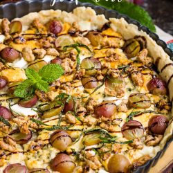This savory Blue Cheese Grape Tart recipe has bold and interesting flavors. It makes a great appetizer or a decadent lunch paired with a green salad. #bluecheese #tart #grapes #redwine #walnuts #candiedwalnuts #appetizer #recipe #Vintijrestaurant #Vintij
