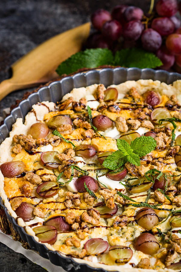 This savory Blue Cheese Grape Tart recipe has bold and interesting flavors. It makes a great appetizer or a decadent lunch paired with a green salad. #bluecheese #tart #grapes #redwine #walnuts #candiedwalnuts #appetizer #recipe #Vintijrestaurant #Vintij