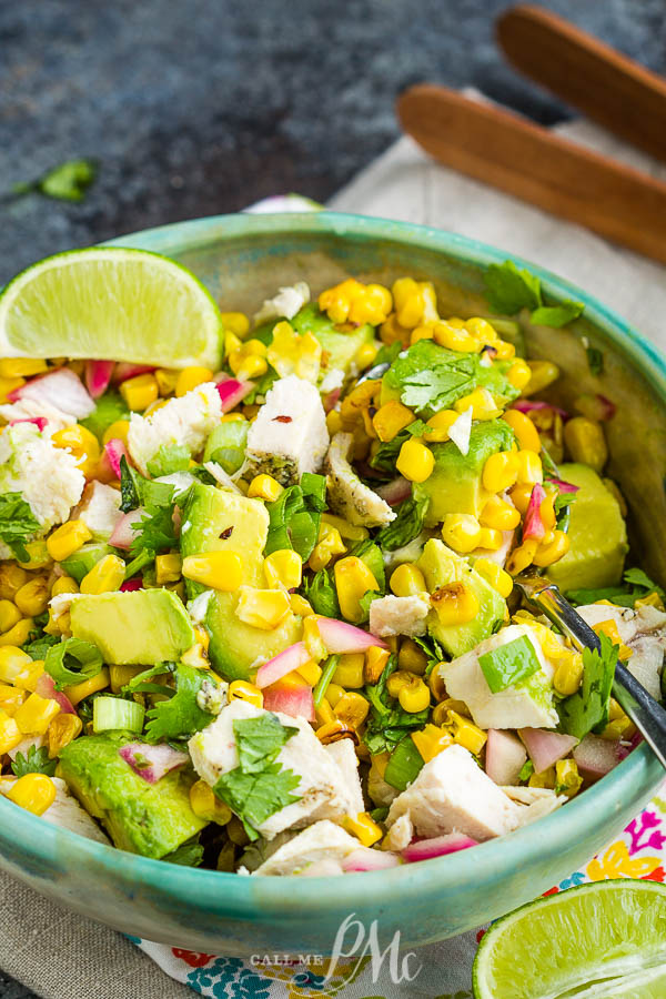 Avocado Chicken Salad Recipe is a hearty mix of grilled chicken, avocado, corn, onions, cilantro, and lime juice. #avocado #chicken #salad #chickensalad #recipe #food #eat #easy #lunch #dinner #picnic Bowl full of food.