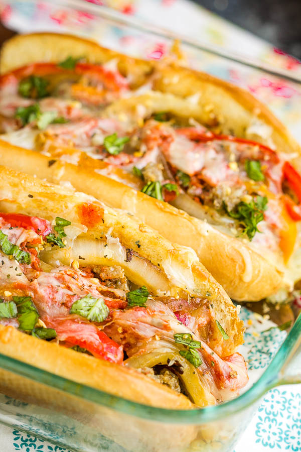 Sausage Pepper Onion Hoagies a delicious, hearty 30-minute meal! Italian sausage, onions, peppers, tomato sauce, and lots of mozzarella make this sandwich a family favorite. #sausage #sandwich #Italian #hoagie #pizza #pizzasandwich #pizzahoagie #pepeprs #onions #Italiansausage #easy #20minute #recipe