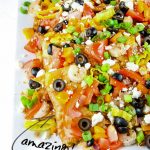 Greek Seafood Nachos are a delicious Mediterranean twist on a snack or dinner recipe. They are a fun and simple dinner solution full of fresh ingredients and flavor! #recipes #Greek #nachos #seafood #shrimp #crawfish #feta #easy #tailgating #party