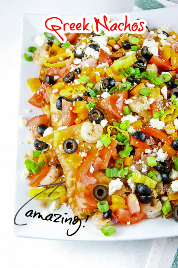 Greek Seafood Nachos are a delicious Mediterranean twist on a snack or dinner recipe. They are a fun and simple dinner solution full of fresh ingredients and flavor! #recipes #Greek #nachos #seafood #shrimp #crawfish #feta #easy #tailgating #party 