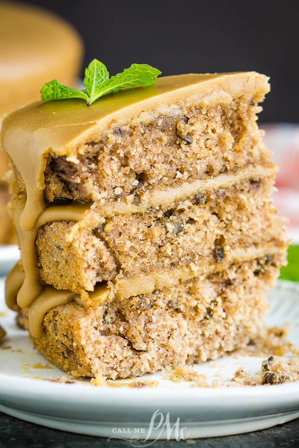 Three layer jam cake with caramel frosting dripping down sides Slice of dessert.