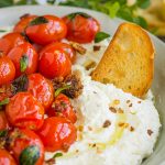 Whipped Feta with Blistered Tomatoes, In this recipe, whipped feta adds a creamy and salty zing and is perfectly balanced by the slightly sweet blistered tomatoes! #feta #cheese #dip #spread #recipe #tomato #grapetomato #cherrytomatoes #appetizer #easy #bruschetta