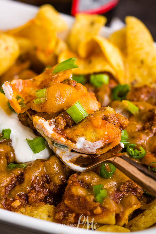 Frito Chili Pie Recipe is classic comfort and gameday food. It's simple, hearty, delicious, takes just minutes to make, and the whole family loves it! #cornchips #Fritos #chips #chili #cheese #cheddar #meal #fastfood #copycat