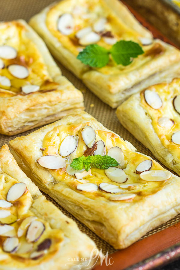 Almond Puff Pastry Danish takes advantage of premade puff pastry for the no-fail pastry base that's filled with a cream cheese honey mixture and topped with almond slivers. #puffpastry #danish #recipe #breakfast #brunch #dessert #almond #baked #homemade #semihomemade Almond Puff Pastry Danish