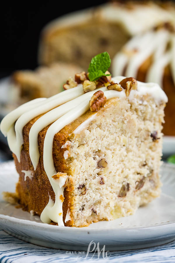 A twist on the classic layer cake, Hummingbird Cake Pound Cake is the ultimate dessert recipe! #cake #poundcake #poundcakepaula #dessert #recipe #bananacake #pineapple #pecans #Thanksgiving #holidayfood #holidayrecipes Slice of dessert on a plate.
