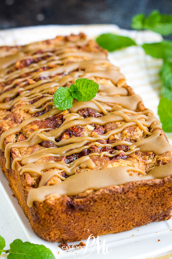 Amish Apple Bread Recipe is loaded with apples and cinnamon and topped with caramel. It's soft, moist, sweet, and delicious, the ultimate fall comfort. #apples #applebread #bread #quickbread #recipe #callmepmc #cinnamon #baking #easy #moist A loaf of bread with frosting.