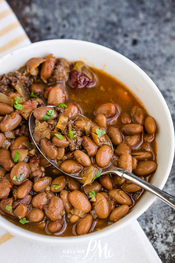 Pinto beans served in a bowl with a spoon Slow Cooker Pinto Beans and Sausage are simple to make with incredible flavor. These beans slow-cooked all day for some delicious comfort food.