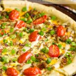 Easy Breakfast Pizza has fluffy eggs, cheese, sausage, ham, bacon on a thick and chewy crust! Sausage Breakfast Pizza with eggs recipe #sausage #bacon #ham #eggs #breakfast #brunch #pizza #breakfastpizza #recipe #callmepmc