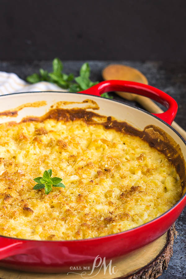 pasta casserole Red round apn with food in it.