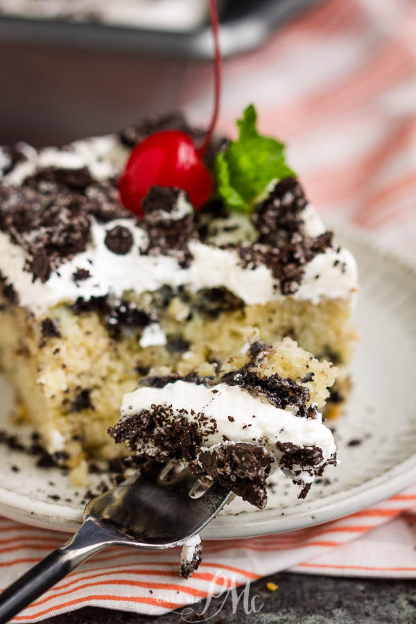 bite of cake on fork Dessert on a plate with a cherry on top.