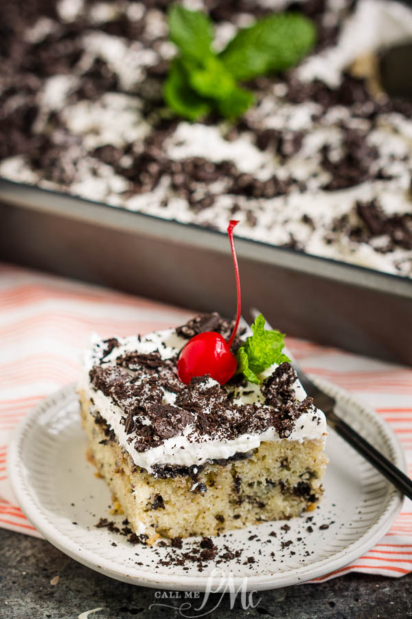 SLICE OF Oreo cake Oreo Poke Cake with a cherry on top.