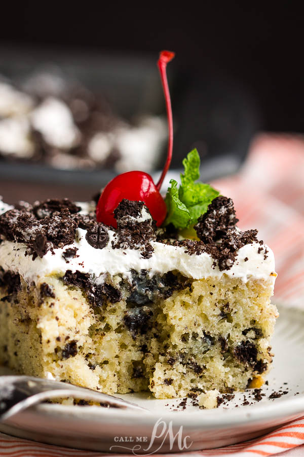 slice of vanilla cake with oreos Dessert on a plate with a cherry on top.