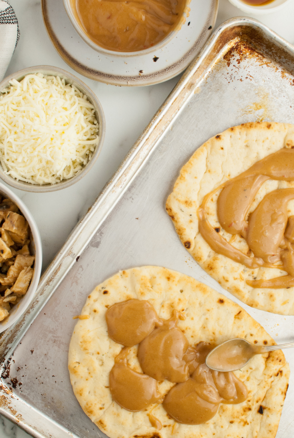 Thai Peanut Chicken Flatbread Recipe, easy college student recipe, bold and delicious flavors like roasted peanuts, tender chicken, and a sweet/spicy sauce