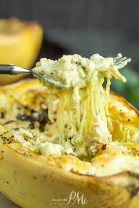 A cheesy fork dives into a garlicky baked spaghetti squash.