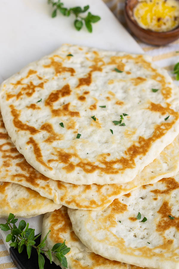 Pillowy soft and fluffy, Biscuit Dough Garlic Naan is pan-seared in minutes with canned biscuit dough. It's perfect for sandwiches, tacos, pizzas, or dipping!