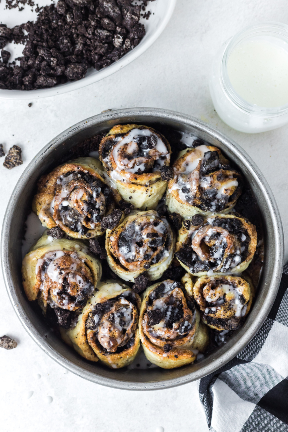 crumbled chocolate cookies on top of cinnamon rolls.