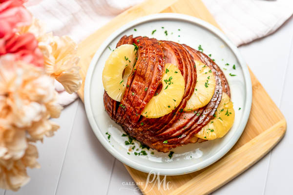 An Instant Pot ham with pineapple and brown sugar on a plate.