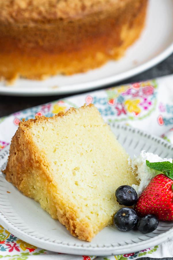 slice of cake on side slice of cake with berries
