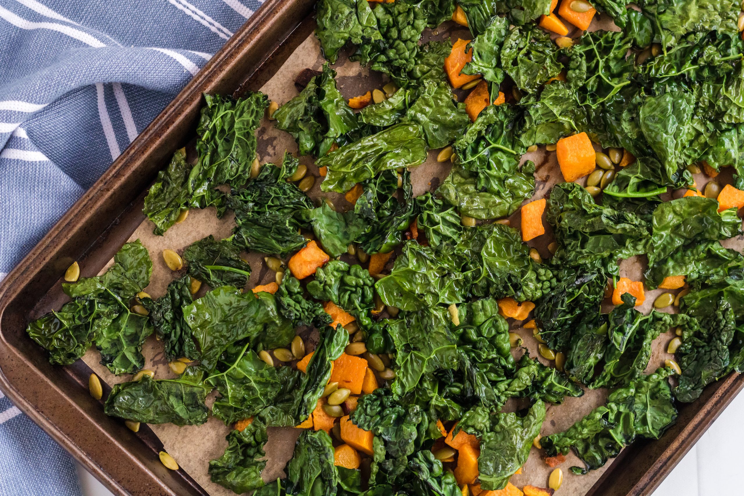 kale and cubed squash on a sheet pan kale and squash on a sheet pan