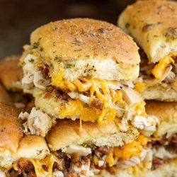 Bacon Chicken Ranch Pull-Apart Sliders recipe is delicious, easy, quick, and always a crowd-pleaser. Made with bacon, chicken, ranch seasoning, soft rolls, and a butter sauce, they're perfect for party or game day appetizers. aka Crack Pull-Apart Sliders, Cheddar Ranch Chicken Sandwiches, Hidden Valley Ranch Chicken Sliders, or Chicken Bacon Ranch on Hawaiian Rolls,