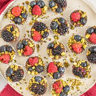 Dark Chocolate Pistachio Berry Cups by callmepmc.com Smooth creamy dark chocolate & almond bark are mixed then topped with pistachios & berries for added flavor. Great for gifts. Perfect for parties. #chocolate #truffles #recipes #gifts #callmepmc