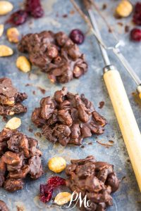 Chocolate cranberry clusters on a baking sheet.