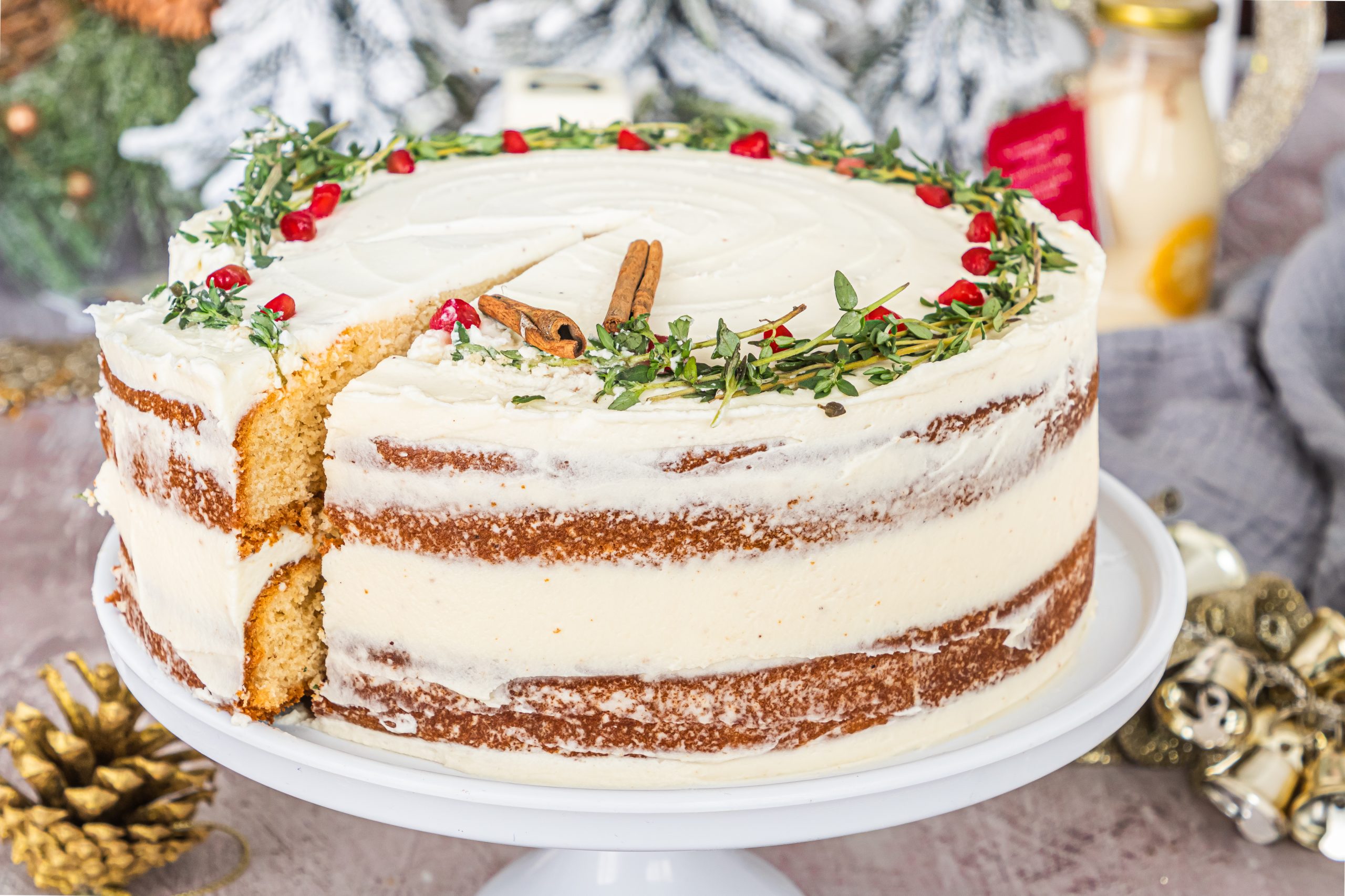 A delightful Christmas cake with a tempting slice missing, featuring an indulgent Eggnog Cream Cheese Icing.
