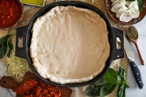 Chicago-style deep dish pizza with a super flavorful crust, stringy mozzarella, tomato sauce, and pepperoni