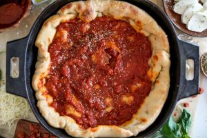 Chicago-style deep dish pizza with a super flavorful crust, stringy mozzarella, tomato sauce, and pepperoni