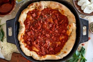 Chicago-style deep dish pizza with a super flavorful crust, stringy mozzarella, tomato sauce, and pepperoni