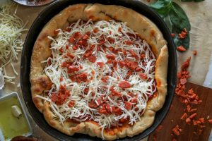 Chicago-style deep dish pizza with a super flavorful crust, stringy mozzarella, tomato sauce, and pepperoni