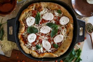 Chicago-style deep dish pizza with a super flavorful crust, stringy mozzarella, tomato sauce, and pepperoni