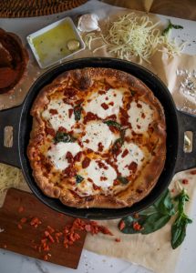 Chicago-style deep dish pizza with a super flavorful crust, stringy mozzarella, tomato sauce, and pepperoni