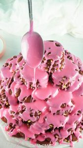 cookie tower decorated with pink frosting.