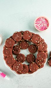 Red Velvet Cookie recipe and How to build a cookie tree. Cookies are stacked to resemble a tree then decorated with frosting & sprinkles.