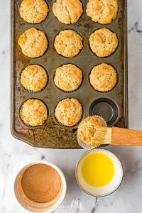 brushing tops of muffins with cinnamon sugar.