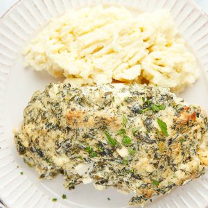 Creamy Baked Spinach Chicken by callmepmc.com. Seared chicken is smothered in cheese and spinach then baked to perfection! It's flavorful, decadent, and hearty.