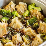 General Tso Potstickers by Call Me PMc are filled with chicken, quinoa, onions, garlic, & soy then cooked in a  sweet, spicy, and tangy sauce with broccoli.