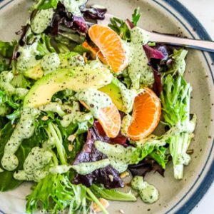 Green Goddess Avocado Orange and Cashew Salad is made with spring greens, avocado, cashews, and oranges and finished with a delightfully refreshing Green Goddess Dressing.
