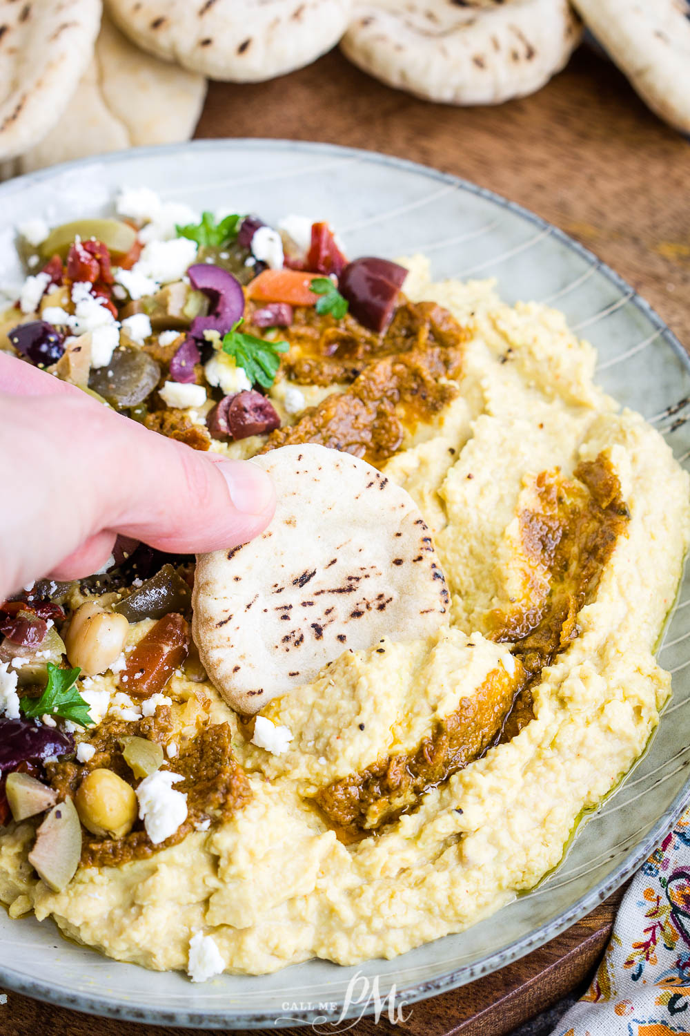 Quick and easy, Pickled Veggie and Tomato Pesto Loaded Hummus, topped with pickled veggies make a simple appetizer dip. Grab some pita rounds and vegetable sticks and let's host a party! dip