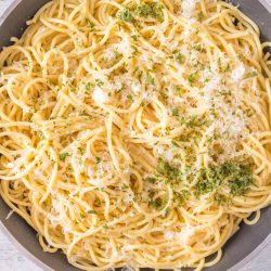 A fast and easy bowl of spaghetti with parmesan cheese and parsley.