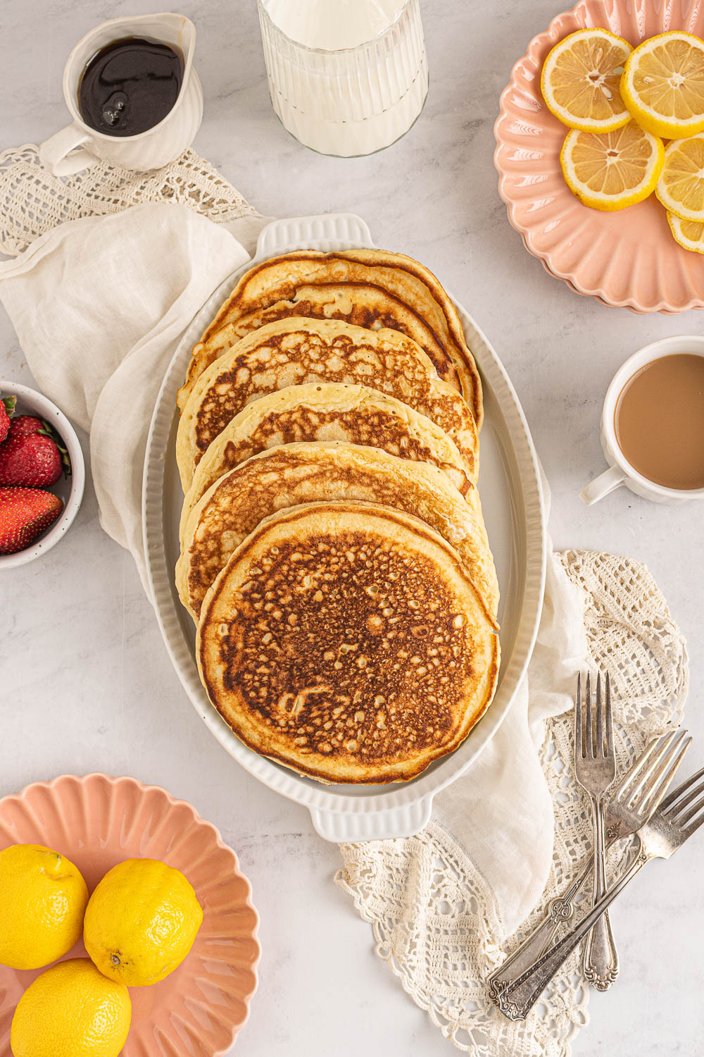 Fluffiest homemade pancakes on a plate with syrup.